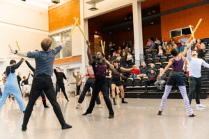 Attendees watch as dancers rehearse scenes from Peter Pan. 